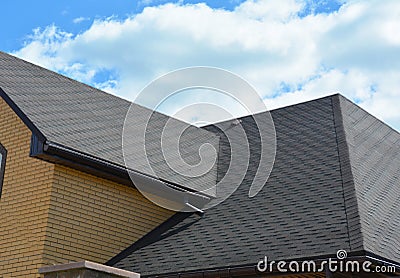 Wateproofing roof problem area with asphalt shingles and rain gutter. Asphalt shingles roofing construction Stock Photo