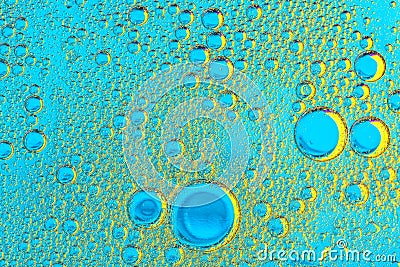 Water bubbles on blue and yellow background. Scientific image of Stock Photo