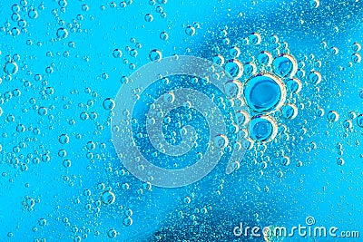 Water bubbles on blue and yellow background. Scientific image of cell membrane. Macro up of liquid substances. Abstract molecule a Stock Photo