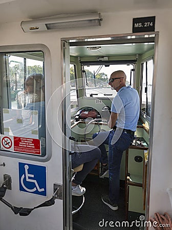 Water bus cabin crew in Venice lagoon, Italy. Editorial Stock Photo