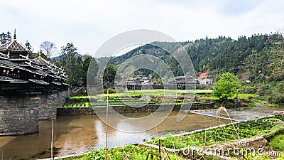 water canal and Chengyang Wind and Rain Bridge Stock Photo