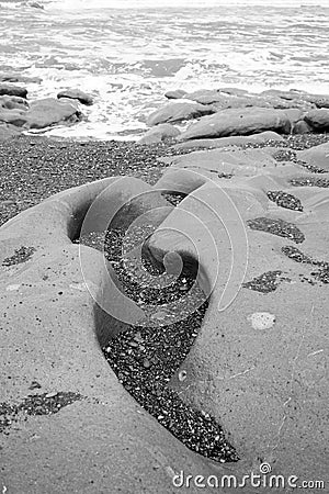 Water carved rock at beach Stock Photo