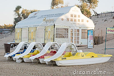 Water catamarans are on the sand in front of a cafe on the beach in the early morning Editorial Stock Photo