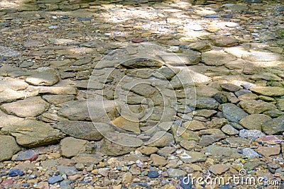 Various sizes of rocks in streams with clear and cool water. Stock Photo