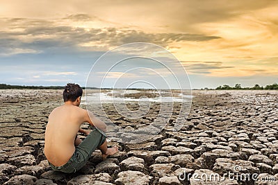 Water crisis, man sit on cracked earth Stock Photo