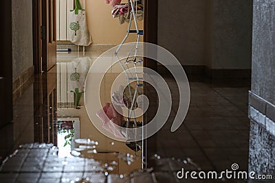 Water damage due a broken pipe. Moisture problem and wet floor. Horizontal, selective focus Stock Photo