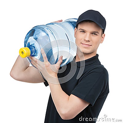 Water delivery. Cheerful young deliveryman holding a water jug w Stock Photo