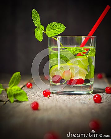 Water detox in a glass beaker. Fresh green mint and berries. A refreshing and healthy drink. Stock Photo