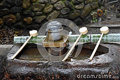 Water dippers in front of shinto shrine Stock Photo