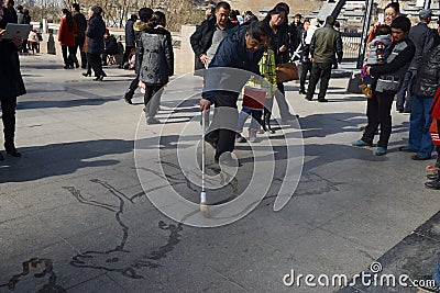 water drawing on the pavement Editorial Stock Photo