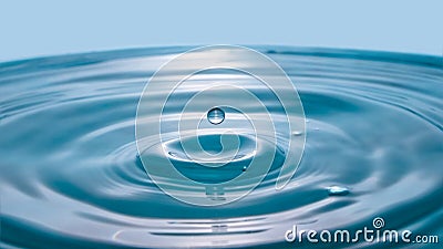 Water drop on blue background. Blue water surface with splash. Clear Waterdrop with circular waves. Splashes closeup. Water splash Stock Photo