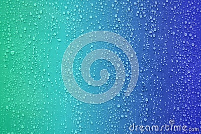 Water drop on blue color gradient background. Stock Photo