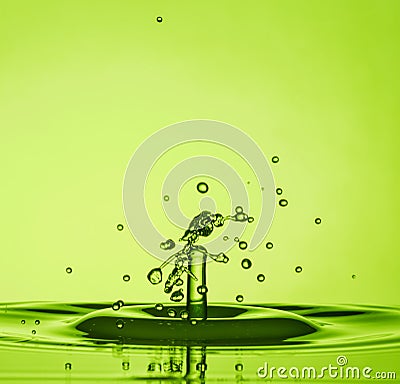 Water Drop Collisions Macro Photography with green background Stock Photo