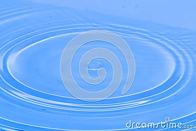 Water drop hits on water surface forms a nice water wave Stock Photo