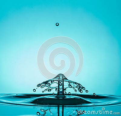 Water Drop Collisions Macro Photography with blue background Editorial Stock Photo