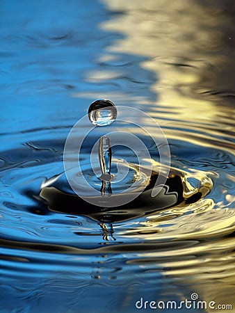 Water Droplet Ripple blue yellow column drop Stock Photo