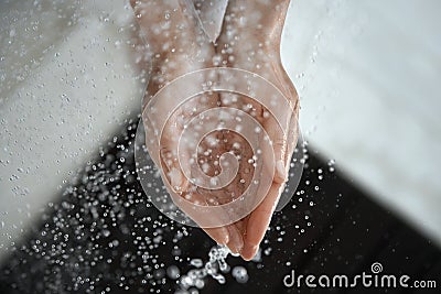 Water Droplets Falling Into Cupped Hands Stock Photo