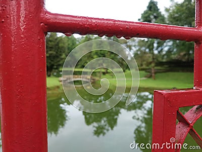 Water Droplets over A Red Fence At Taiping Lake Garden, Taiping Perak Stock Photo