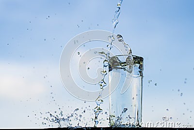 Water dropping into the glass. Stock Photo