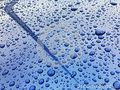 Water drops at blue car paint. Polishing and detailing cars Stock Photo