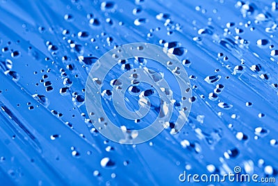 Water drops on a cellophane film, dark blue toning Stock Photo