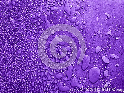 water drops of different sizes on a purple surface, drops texture, rain on violet tile, rain texture, mauve refreshing background Stock Photo