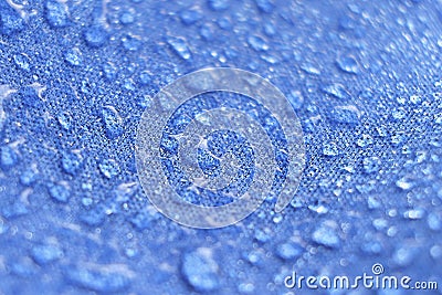 Water drops on the fabric. Rain Water droplets on blue fiber waterproof fabric. Water drops pattern over a waterproof Stock Photo