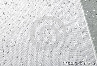 Water drops on waterproof fabric background. Raindrops on white umbrella Stock Photo