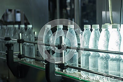 Water factory - Water bottling line for processing and bottling pure spring water into small bottles Stock Photo