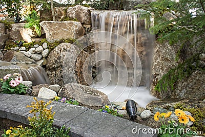 Water Feature with pond and flowers Stock Photo