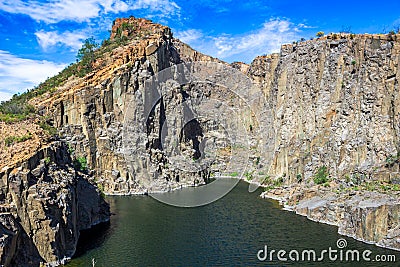 Water filled dolerite rock quarry Stock Photo