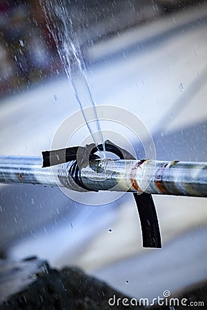 Water flowing loss from old metal pipe line Stock Photo