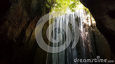 Water flows into a cave, a crevice. Stock Photo