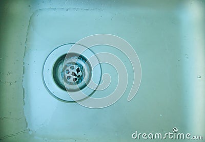 Water flows down the pipes sink. Stock Photo