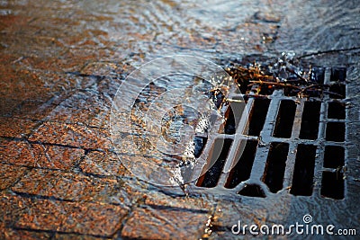 Water flows into the hatch on a spring sunny day Stock Photo