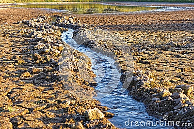 Water flows into the pond shrinking Stock Photo