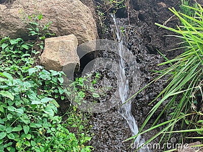 Water flows beside a stone at Pasuruan East Java Stock Photo