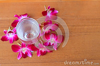 Water glass cool with orchid purple on wooden floor board with copy space add text Stock Photo