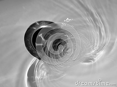 Water going down plughole, drain. Waste. Stock Photo