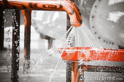 Water gushing out of the hole of plastic pipe Stock Photo