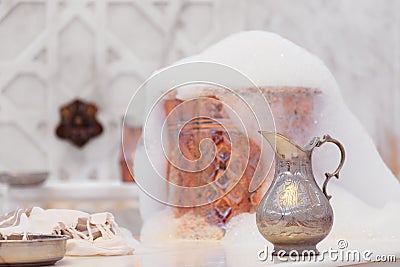 Water jar, towel and copper bowl with soap foam in turkish hamam. Traditional interior details Stock Photo