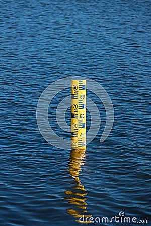 Water level meter located in the water of the dam. Concepts for natural resources. Water level gauges in the background is the re Stock Photo