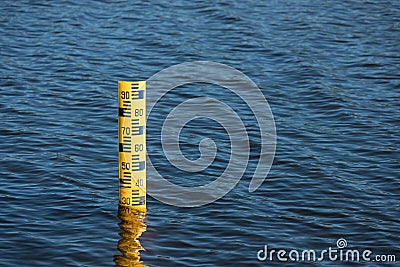 Water level meter located in the water of the dam. Concepts for natural resources. Water level gauges in the background is the re Stock Photo