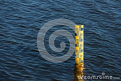 Water level meter located in the water of the dam. Concepts for natural resources. Water level gauges in the background is the re Stock Photo