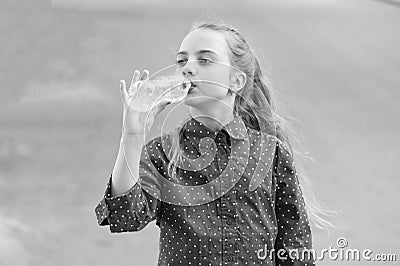 Water is life. Thirsty child drinking fresh water from plastic bottle. Little girl having a drink from water bottle Stock Photo