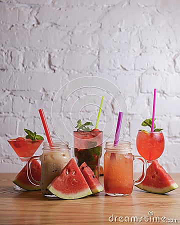 Water melon cocktails with fresh melon and boba bubble tea, on a table over white brick background. Stock Photo