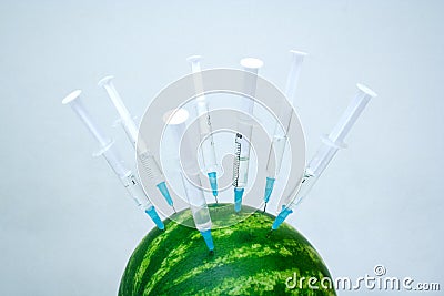 Water melon with a hypodermic syringes Stock Photo