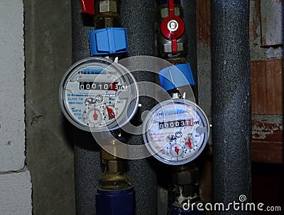 Water meter measuring devices for cold and hot water usage Stock Photo