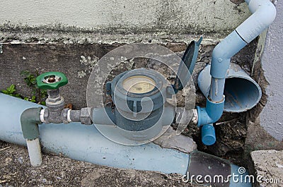 Water meter and valve of waterworks near old wall Stock Photo