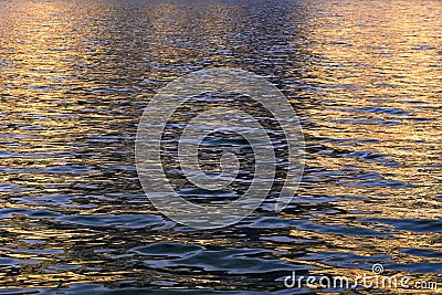 Water and mirroring evening sun Stock Photo